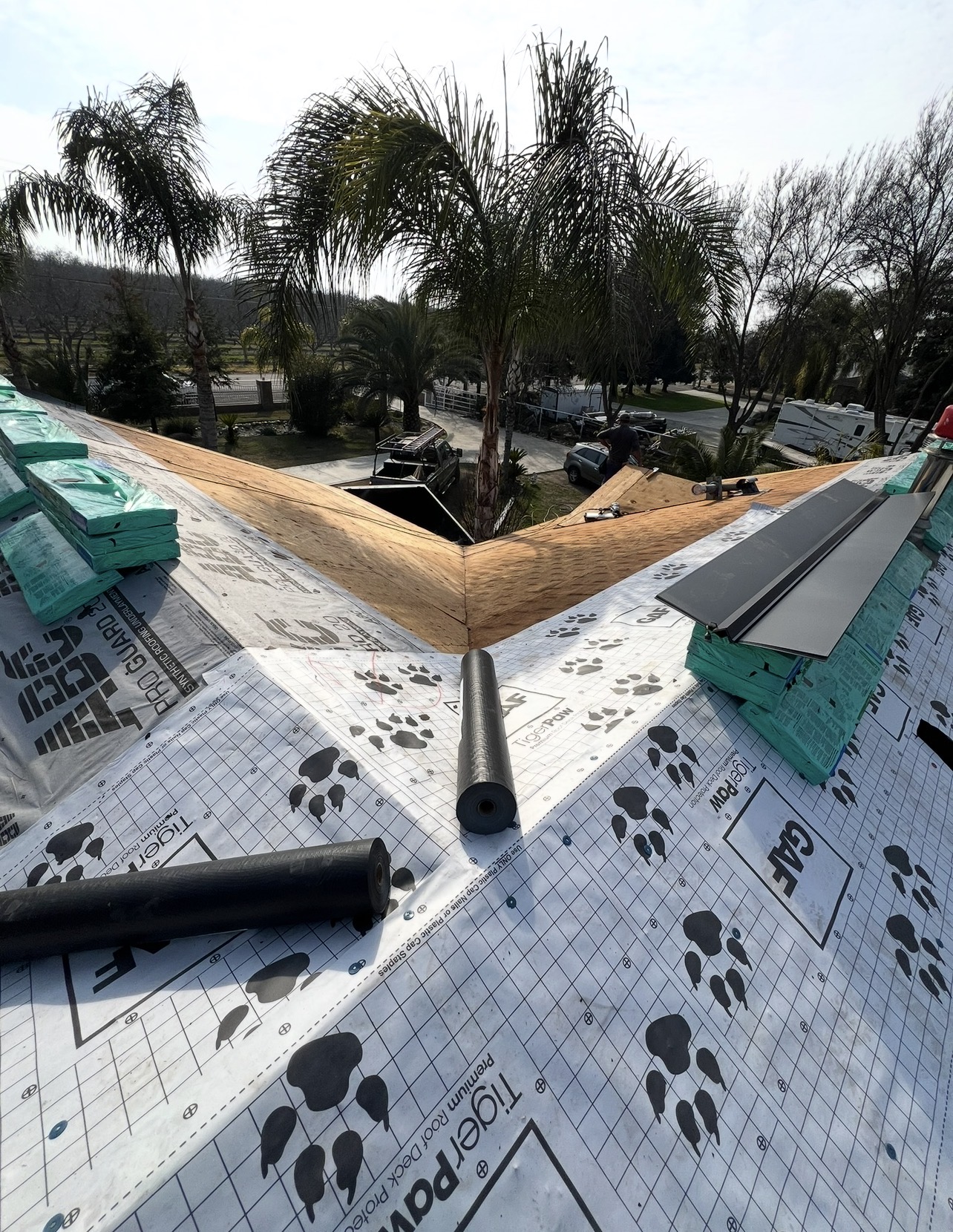 Residential roof with underlayment and ridge detail work in progress