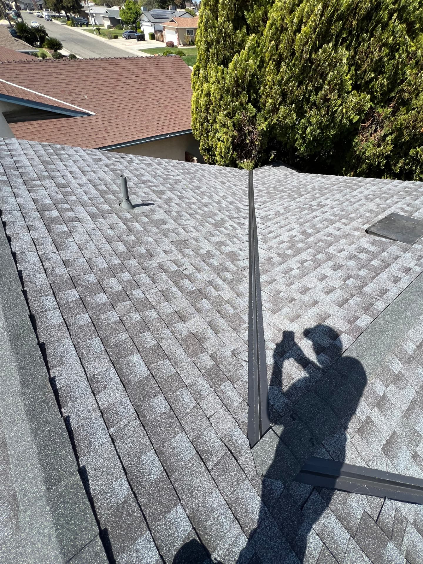 Finished shingle roof with new ridge vent detail
