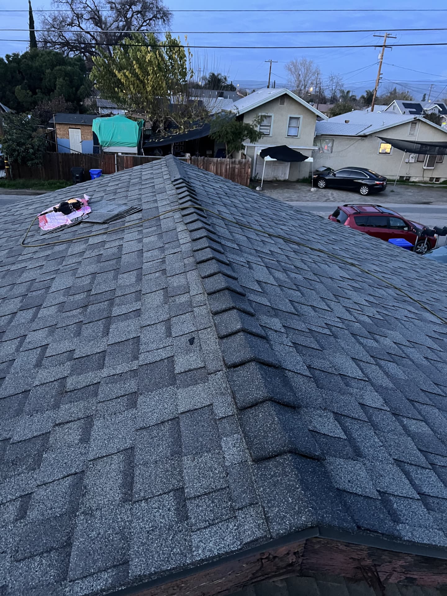 New gray shingle roof with finished hip and ridge caps