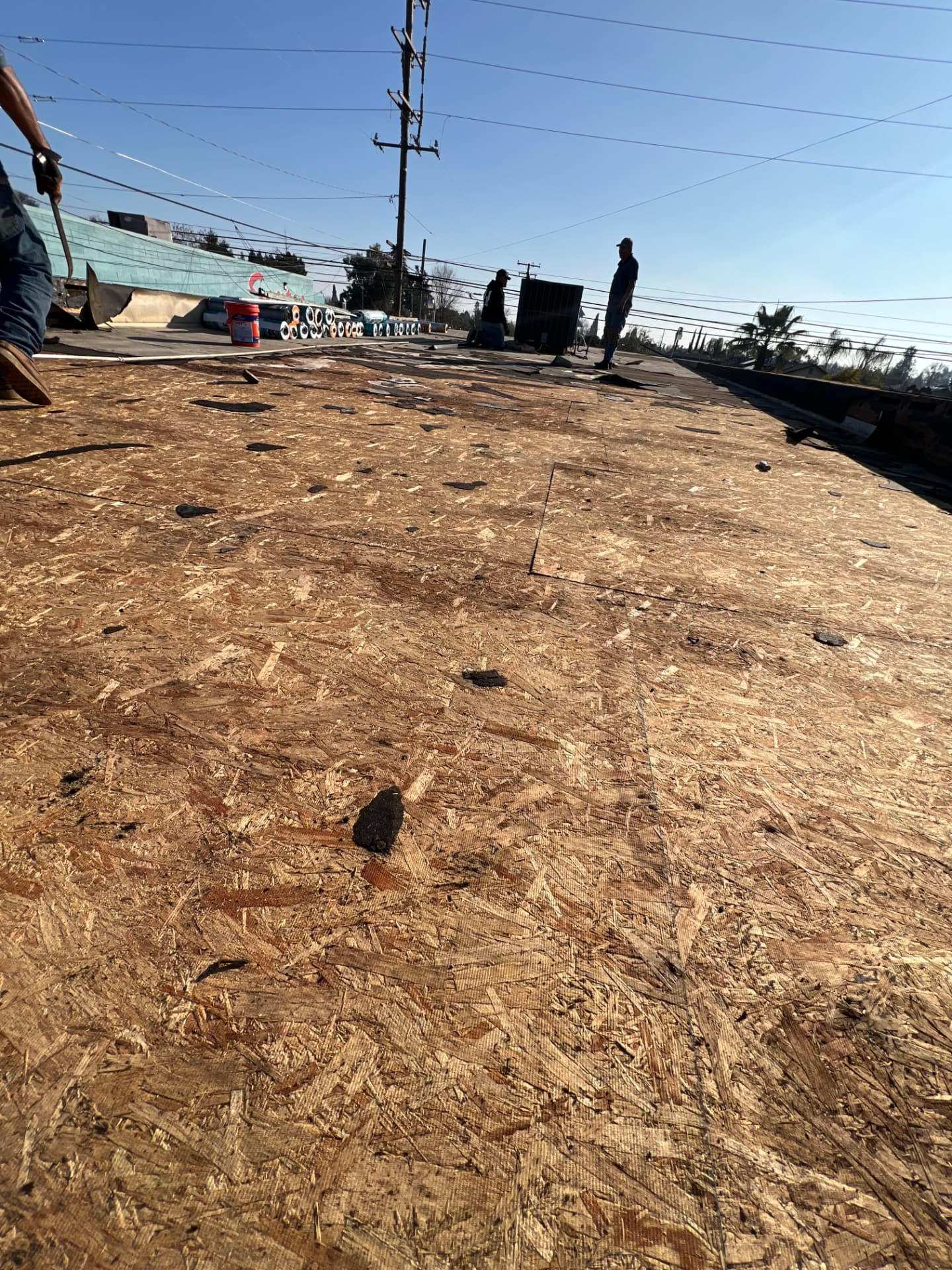Commercial roof deck installation with workers preparing the new system
