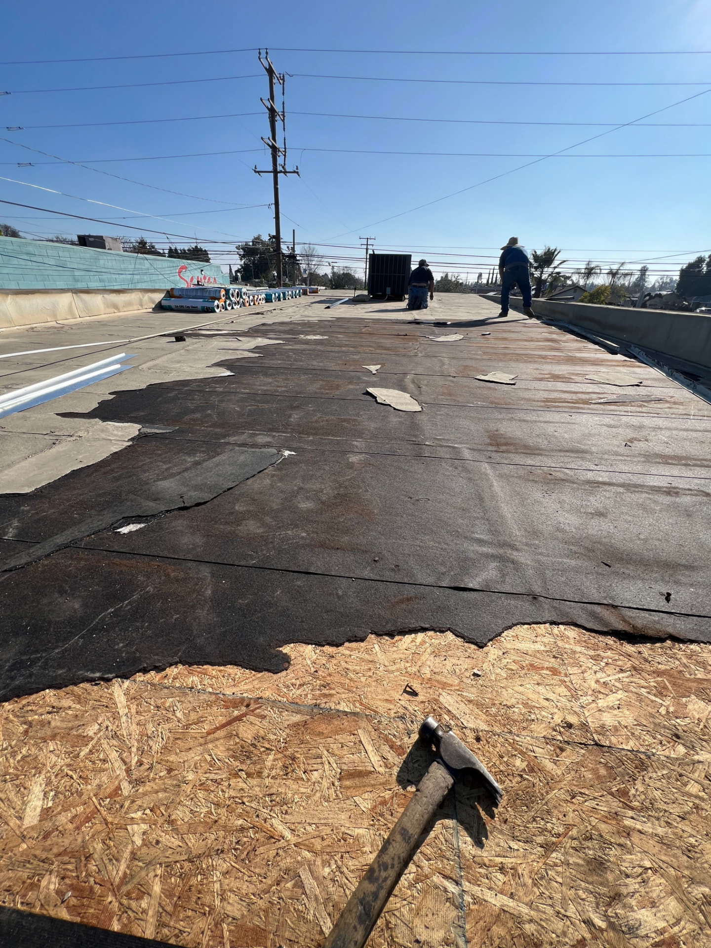 Commercial roof tear-off down to the plywood deck before new system install