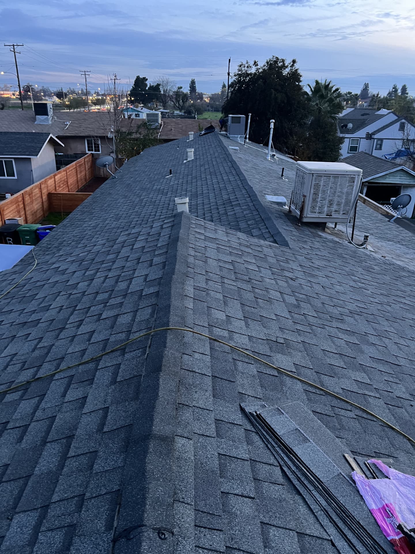 Completed architectural shingle roof on a Visalia home at dusk