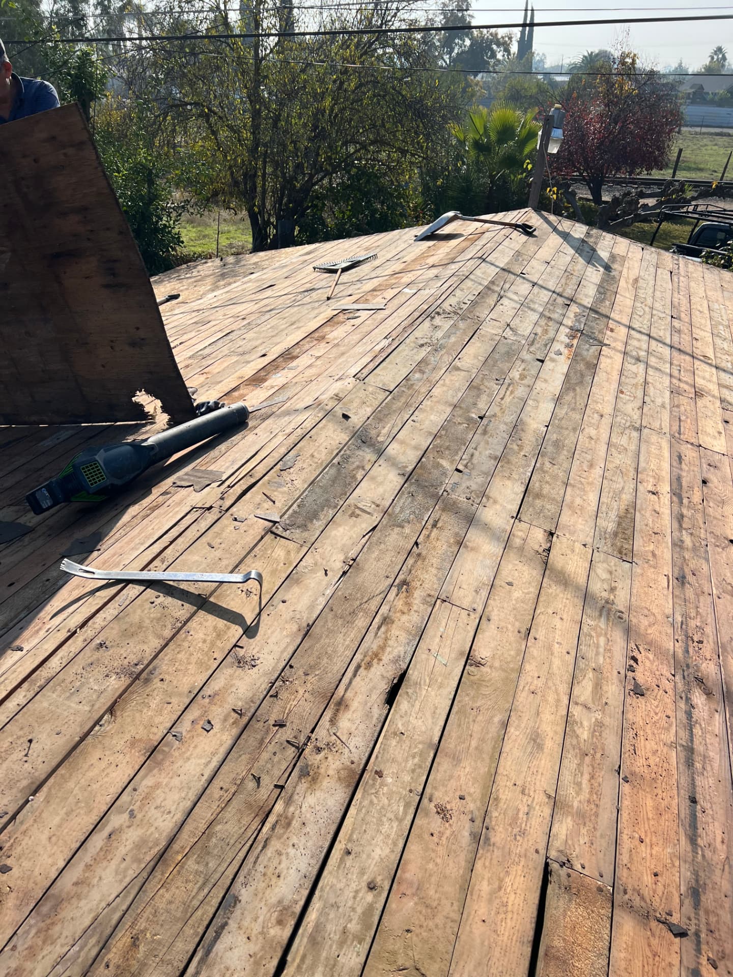 Residential roof deck stripped to wood planks during tear-off