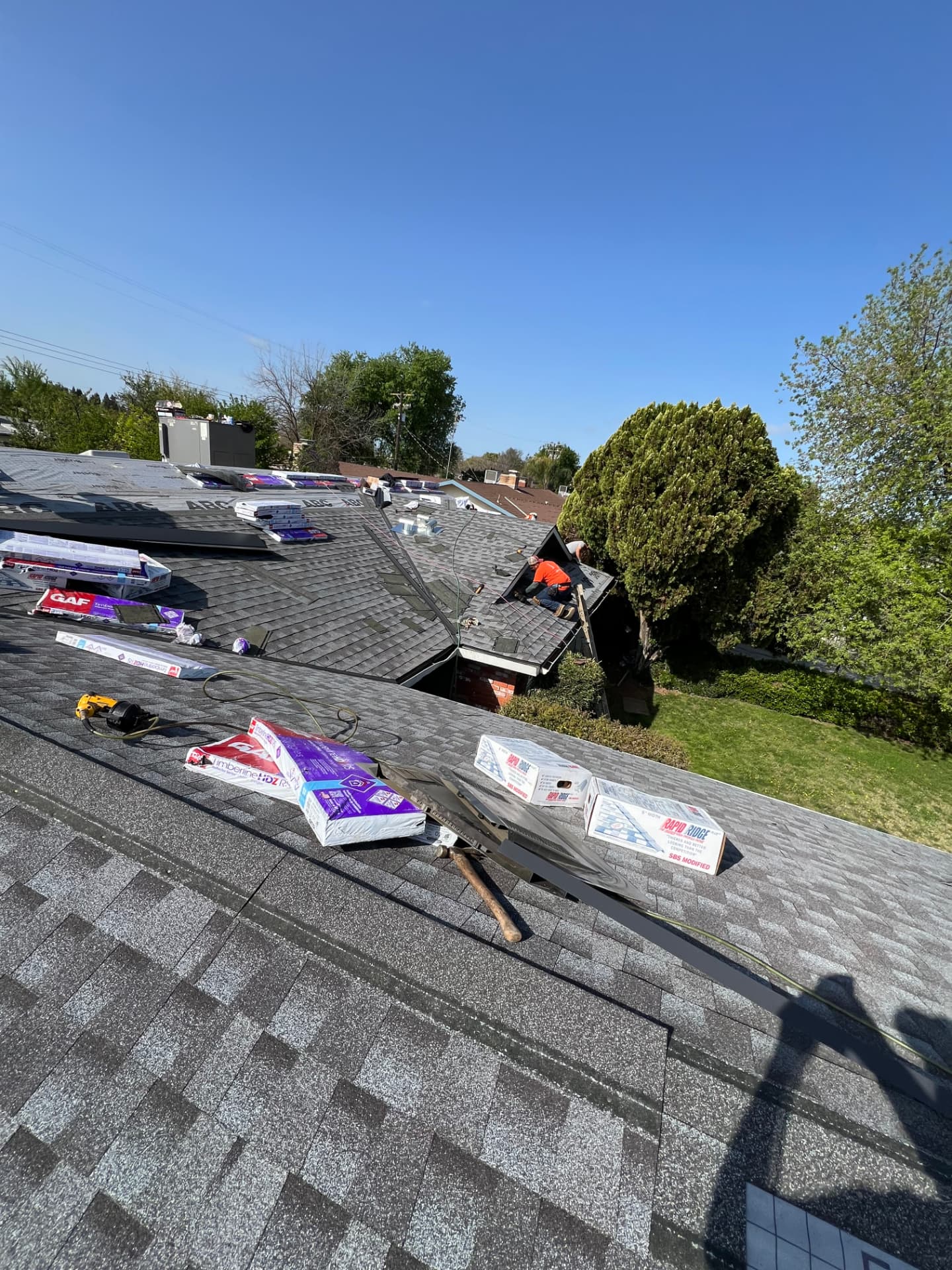 GAF Timberline shingles and ridge cap materials staged on a roof