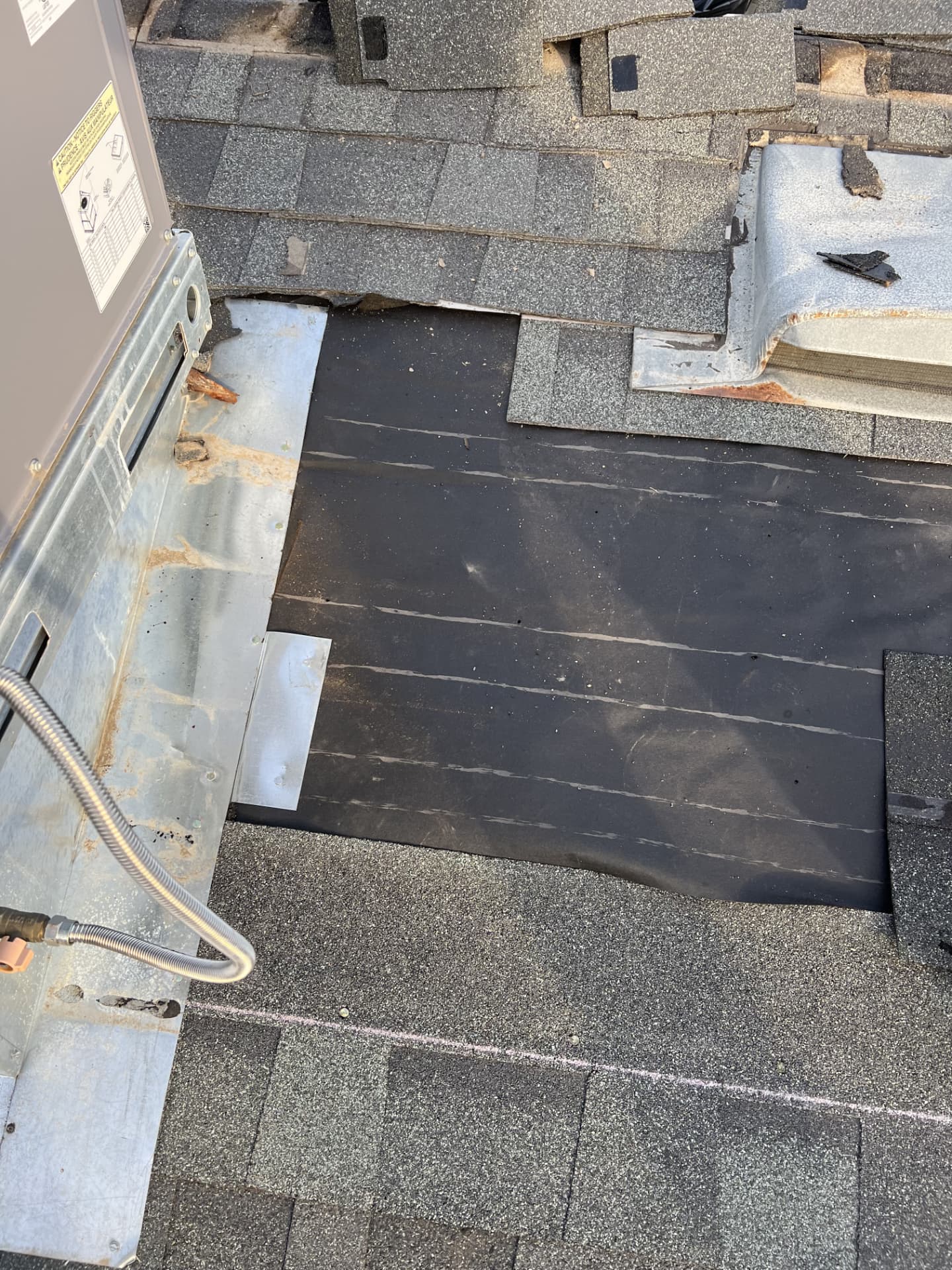 Flashing and underlayment repair around a rooftop HVAC unit