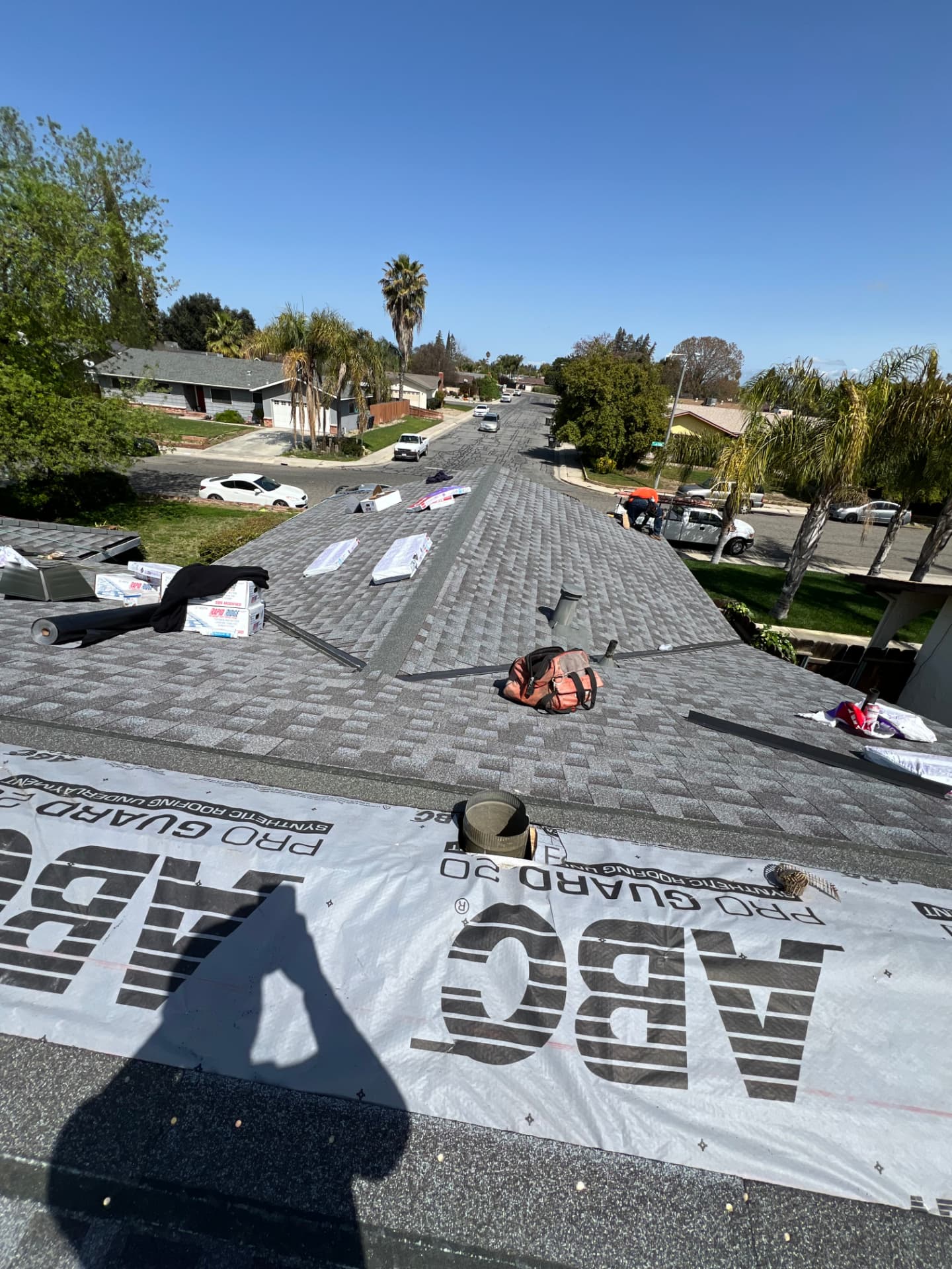Shingle installation in progress over synthetic underlayment