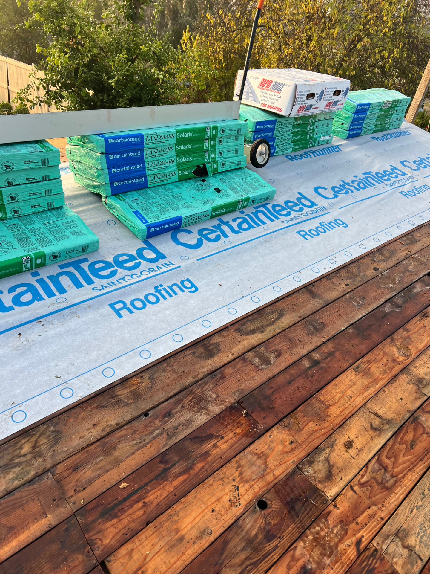 CertainTeed underlayment and Landmark Solaris shingle bundles on a residential roof